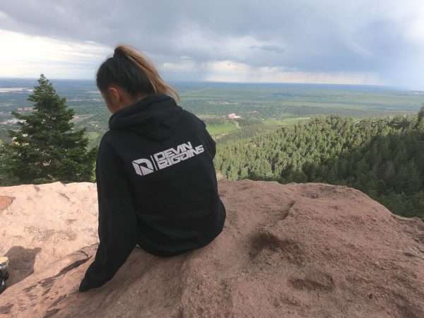 Scenic outlook with a girl weating a black Devin Riggins Hoodie